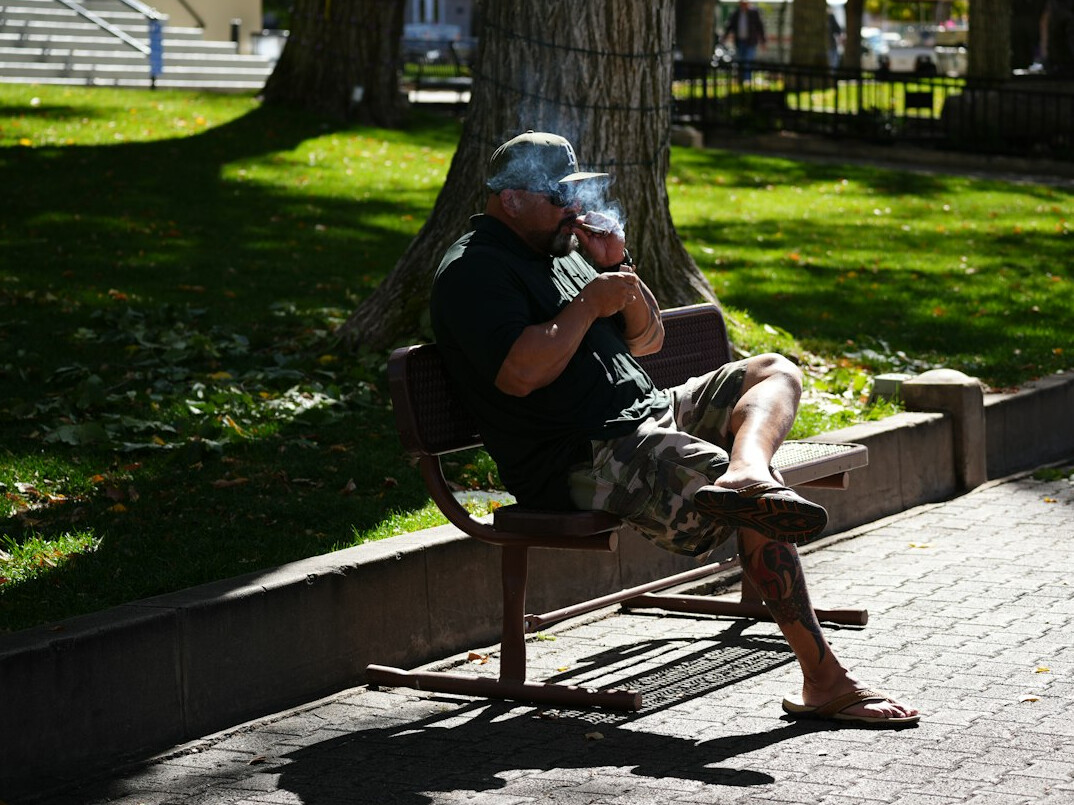 elderly man drinking tea in park