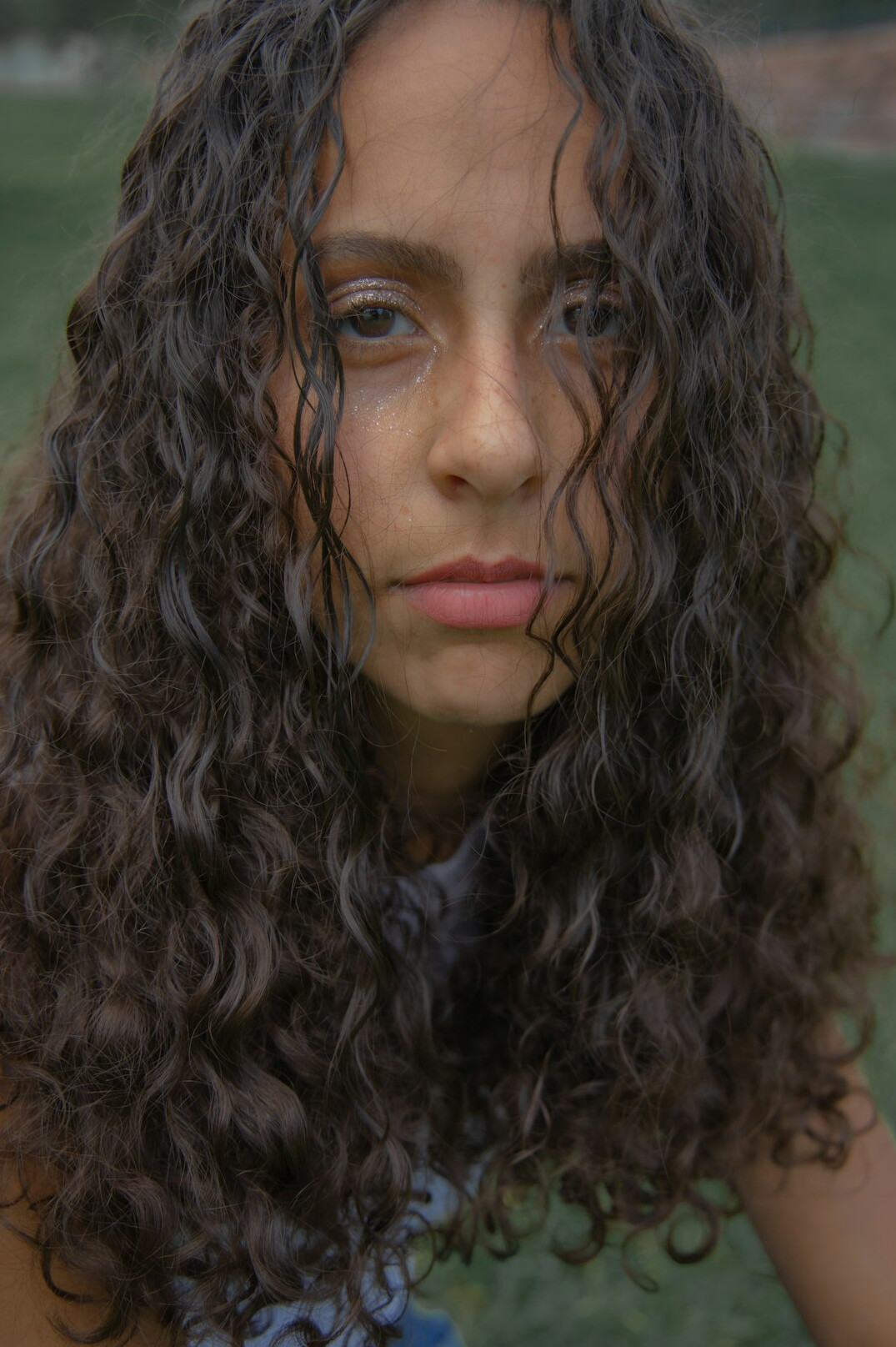 Studio portrait of a young Chilean woman with curly hair